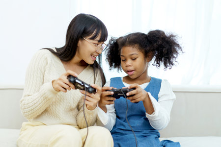 Concept of diversity in ethnic people spending a time together in a weekend. A diverse group and generation people relaxing and playing a video game together in living room.の写真素材