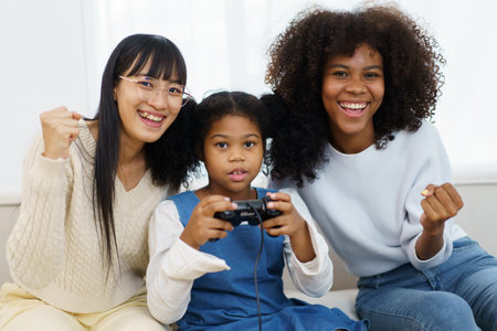 Concept of diversity in ethnic people spending a time together in a weekend. A diverse group and generation people relaxing and playing a video game together in living room.の写真素材