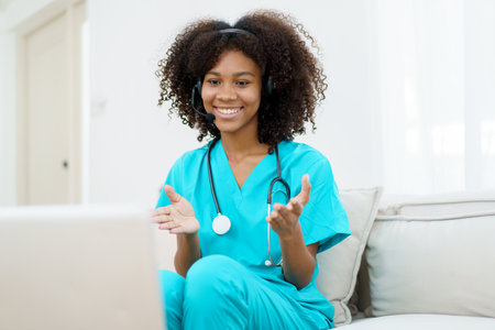 American - African black ethnicity female doctor gives a consultation to patient, online or tele medicine service. Doctor talking to patient through online video conference.の写真素材