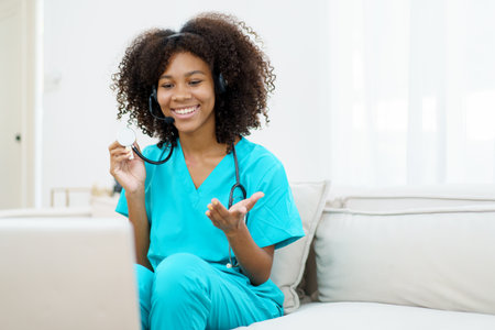 American - African black ethnicity female doctor gives a consultation to patient, online or tele medicine service. Doctor talking to patient through online video conference.の写真素材