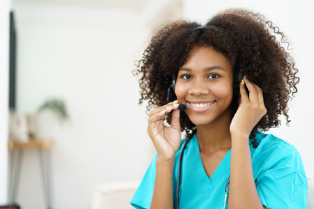 American - African black ethnicity female doctor gives a consultation to patient, online or tele medicine service. Doctor talking to patient through online video conference.の写真素材