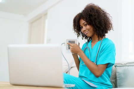 American - African black ethnicity female doctor gives a consultation to patient, online or tele medicine service. Doctor talking to patient through online video conference.の写真素材