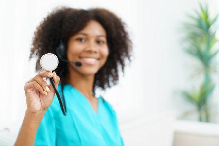 American - African black ethnicity female doctor gives a consultation to patient, online or tele medicine service. Doctor talking to patient through online video conference.の写真素材