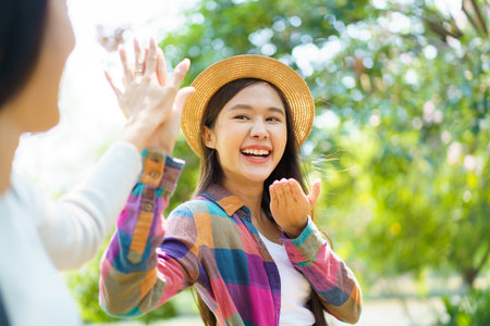 Asian women touching their fingers together. Concept of trust and friendship.の写真素材