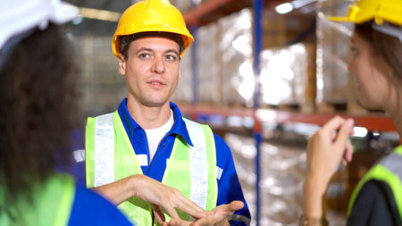 Happy Asian senior supervisor working - inspecting an items in the warehouse, smart and good looking handsome Asian man portrait while working in the warehouse. Warehouse worker working.の写真素材