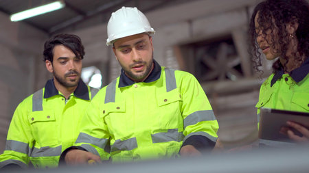 Group of professional mechanical engineer or technician working together in the factory and making a handshake after finished working.の写真素材