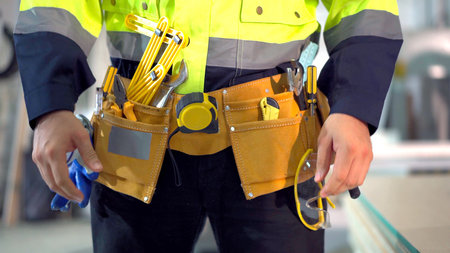 professional foreman or mechanical engineer preparing - dressing himself the a safety vest and helmet before getting to work.の写真素材