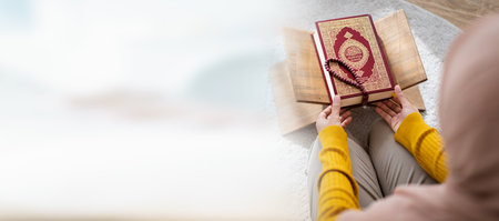 Beautiful Asian young Muslim woman sit on the floor in her house and praying for a holy god - Allah in Islam believe.の写真素材