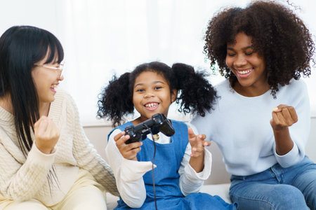 Concept of diversity in ethnic people spending a time together in a weekend. A diverse group and generation people relaxing and playing a video game together in living room.の写真素材