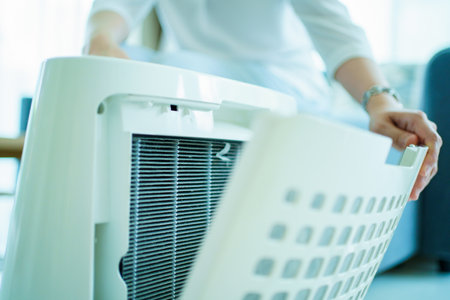 Asian woman changing the dirty air purifier filter after using for a long time in the dirty air...