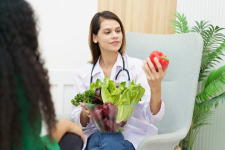 Female woman having a consulting with a professional doctor or nutritionist about eating and nutrition. Doctor explaining to female patient about healthy eating and dieting.の写真素材