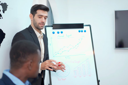 Group of diverse ethnicity businesspeople in meeting room discussing about annual business plan or...
