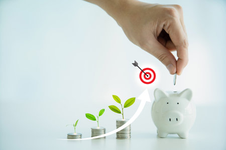 Little saving piggy on the table with blurred background close up with copyspace. Money saving and wealth concept.の写真素材