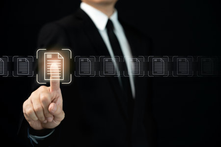 Recognizable businessman choosing a document digitally on beautiful holograms, close up of businessman touching on virtual document or paper.の写真素材