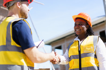 Construction foreman and client making a handshake together after completed the new contract.