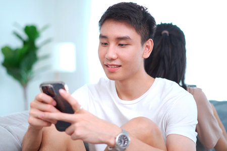 Problem in modern lifestyle young family or couple, they separate - ignoring each other and always playing a smartphone devices.の写真素材