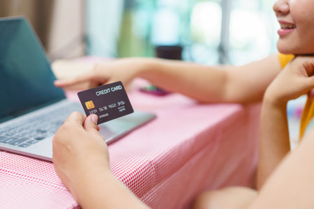 Happy Asian fat women friend excited in online shopping with special discount and using credit card to make a payment. Two Asian fat women staying together and buying goods in e-commerce website.の写真素材