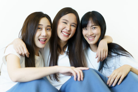 Happy beautiful Asian young women staying together in bedroom.の写真素材