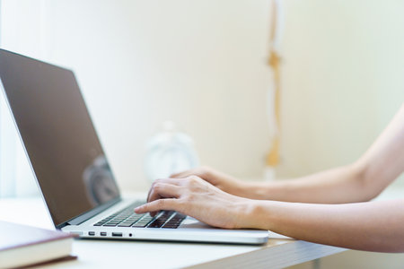 Asian beautiful woman checking e-mail and browsing the internet on laptop - notebook computer in morning. Woman working from home. Modern working lifestyles concept.の写真素材