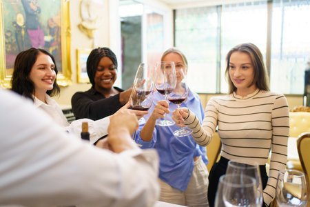 Group of diverse ethnicity people enjoy testing red wine together.の写真素材