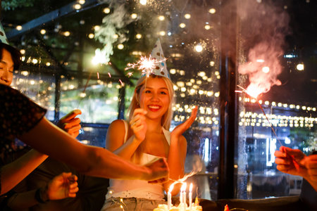 Group of young people enjoy celebrating a birthday and new year together, people in festive party....