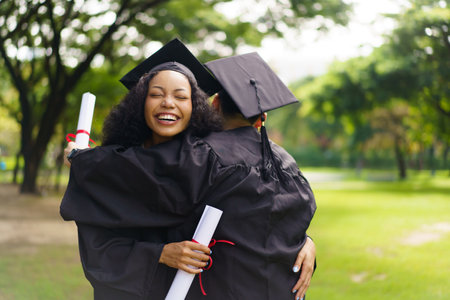 Group of students in graduation gown has an excited and delighted expression as they receive their diploma upon graduating from university. Diverse student feel proud about academic achievement.の写真素材