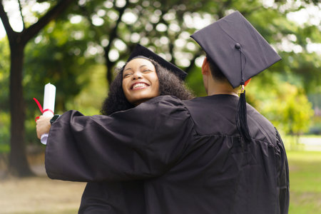 Group of students in graduation gown has an excited and delighted expression as they receive their diploma upon graduating from university. Diverse student feel proud about academic achievement.の写真素材