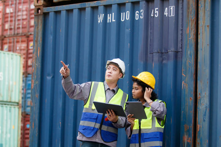 Businesswoman and ship yard engineer are having a discussion about oversea import and export...