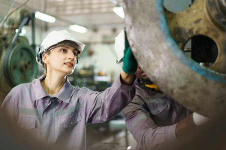 Team of technicians or engineers are inspecting a machines in the factory. Engineers team arrange a...