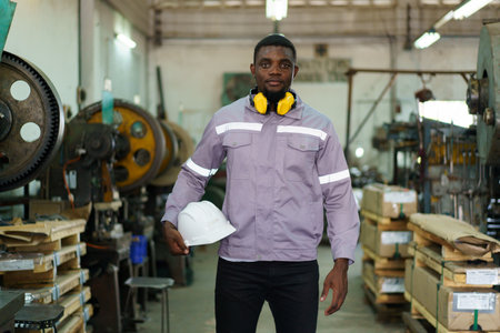 Smart and good looking African Black ethnicity male industry engineer performs inspection machines....