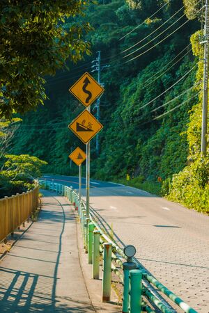 Signs on curves and slopes road on mountain.の写真素材