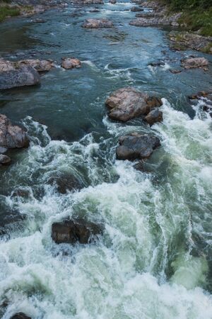 Water flowing over rocks on top view.の写真素材