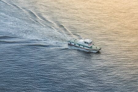 Speed boat on the sea at sunset time.
