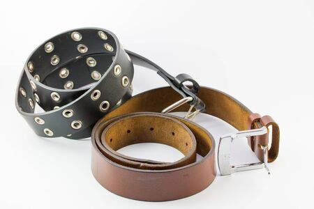 Old two leather belt roll on white background.の写真素材