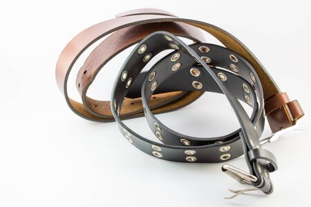 Old two leather belt roll on white background.の写真素材