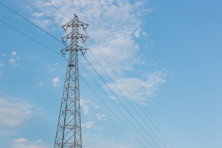 Mast electrical power line against cloud and blue sky.の写真素材