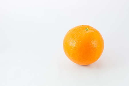 Single orange on white background concept.