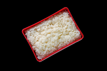 Japan rice in red box bento isolated on black background.の写真素材