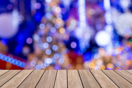 Christmas holiday background with empty wooden deck table over festive bokeh. Ready for product montage.の写真素材