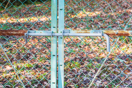 Old fence locked metal door with rusty.の写真素材