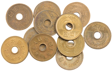 Pile of 5 yen coins japanese money, close up isolated on white background.の写真素材