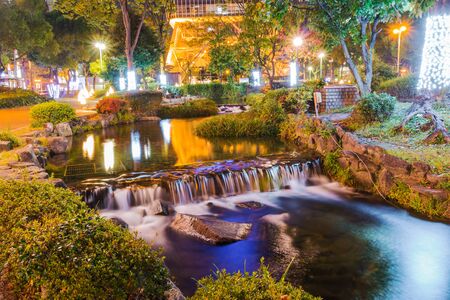 Mini waterfall in city on night time.の写真素材