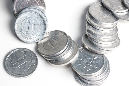 Pile of 1 yen coins japanese money, close up isolated on white background.の写真素材