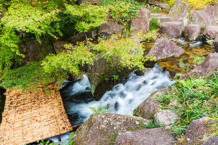Beautiful Waterfalls with bamboo bridge in forest.の写真素材