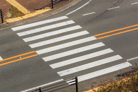 Urban pedestrian crosswalk across an asphalt street in city.の写真素材
