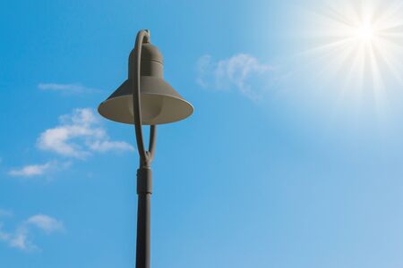 Lamp post in the sky with sun.の写真素材