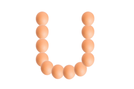 U,Egg alphabet uppercase on white background.の写真素材
