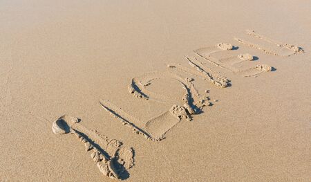 Word "I love U" hand written on a beach.の写真素材