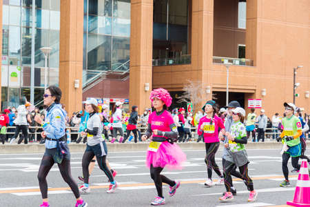 NAGOYA, JAPAN - MARCH 13, 2016: Nagoya Women's Marathon 2016. Women's With more than 3,000 People running in the downtown. Course Start and finish at Nagoya Dome Distance 42.195km. Nagoya city Japan.のeditorial素材