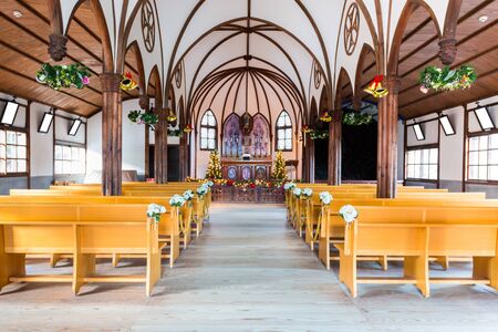 church interior with empty a row of wooden pews.のeditorial素材